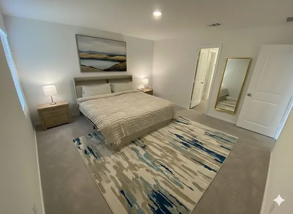 a bedroom with a bed and a mirror