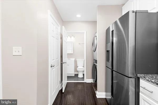 a open kitchen with white cabinets and stainless steel appliances
