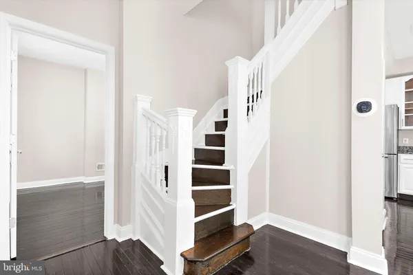 a view of an empty room with wooden floor