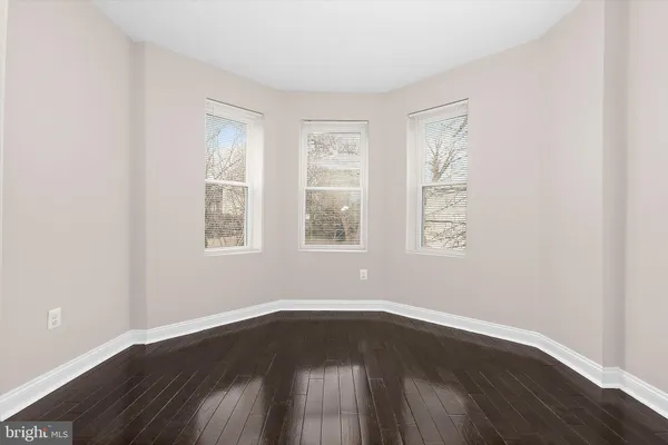 an empty room with wooden floor