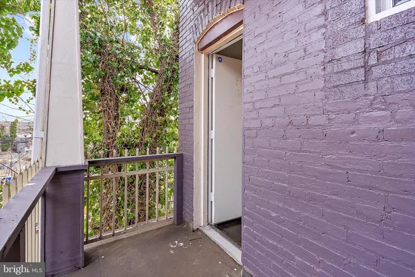 a view of a backyard with a fence and trees