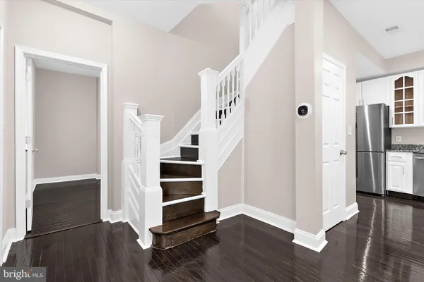 a kitchen with granite countertop white cabinets and stainless steel appliances