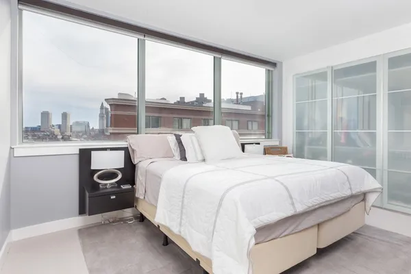 a bedroom with a bed and window