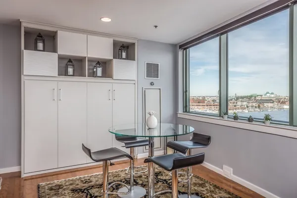 a dining room with furniture and a window