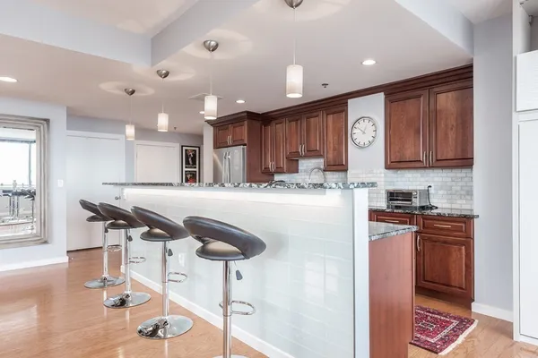 a kitchen with stainless steel appliances kitchen island granite countertop a sink and cabinets