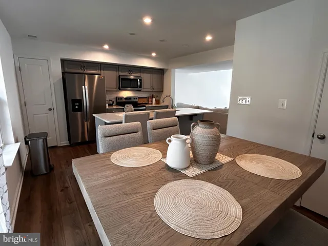 a dining room with furniture a window and kitchen view
