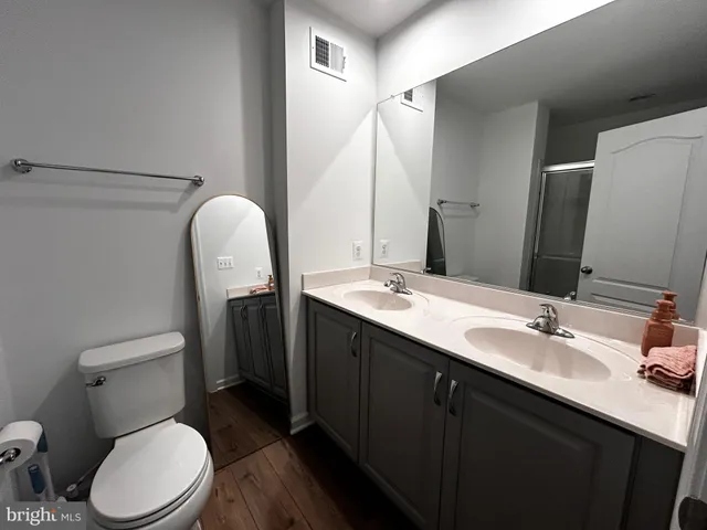 a bathroom with a toilet sink and mirror