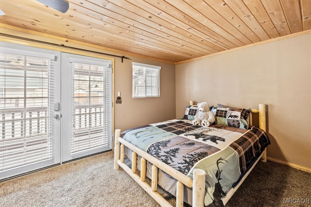 44361 Silver Pine Road Sugarloaf, CA 92386 - Photo 12 of 20 a bed sitting in a bedroom next to a window