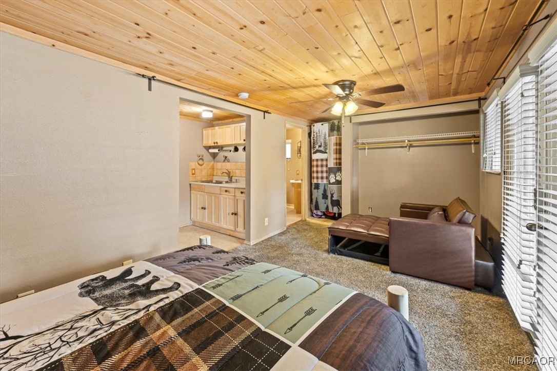 44361 Silver Pine Road Sugarloaf, CA 92386 - Photo 14 of 20 a bedroom with a bed and wooden floor