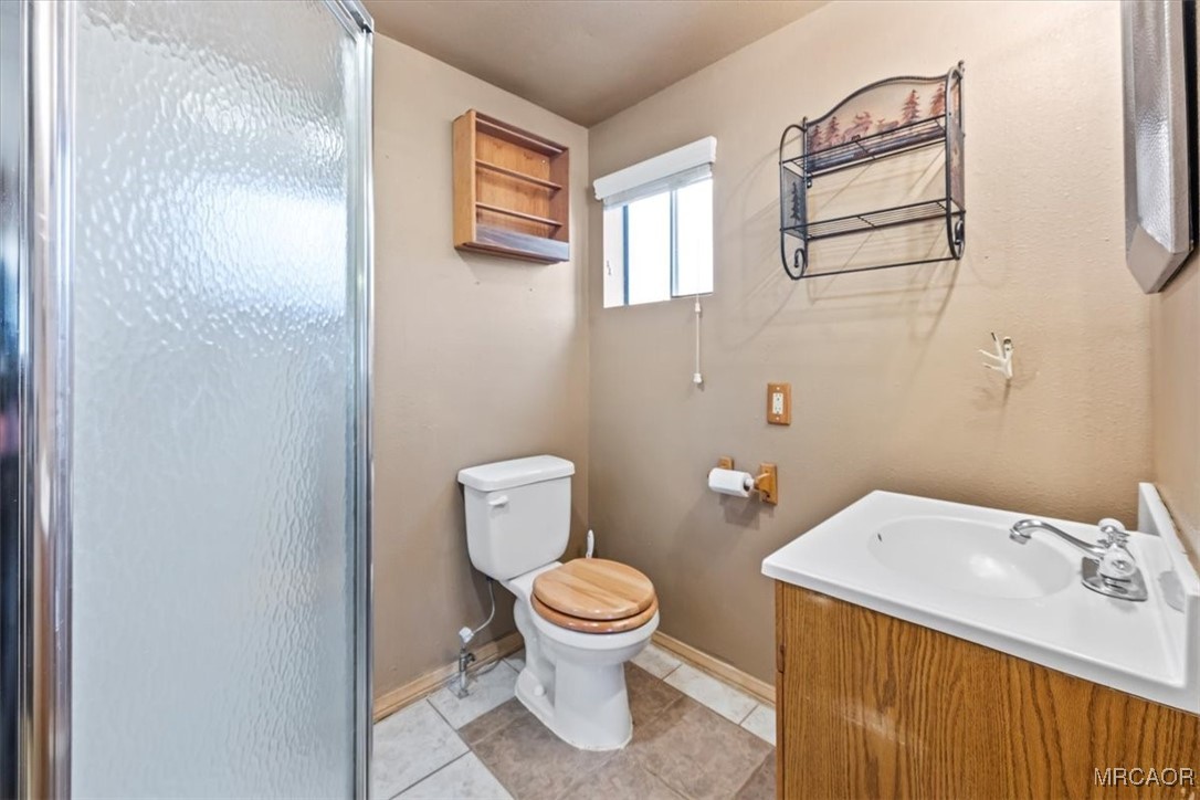 44361 Silver Pine Road Sugarloaf, CA 92386 - Photo 16 of 20 a bathroom with a toilet sink and mirror