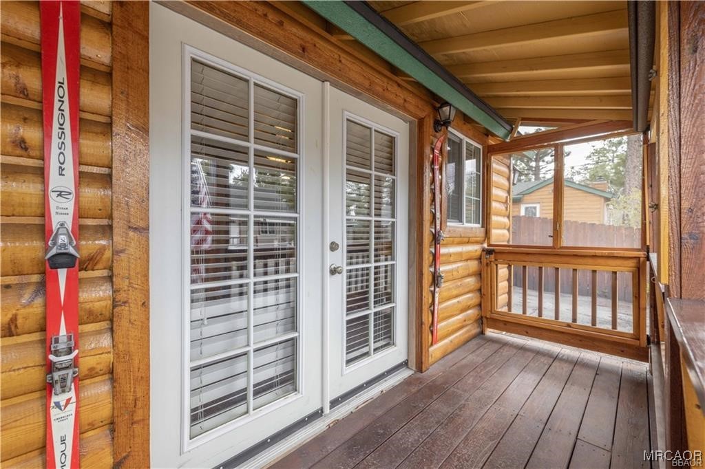 44361 Silver Pine Road Sugarloaf, CA 92386 - Photo 4 of 20 a view of a balcony with wooden floor and iron stairs