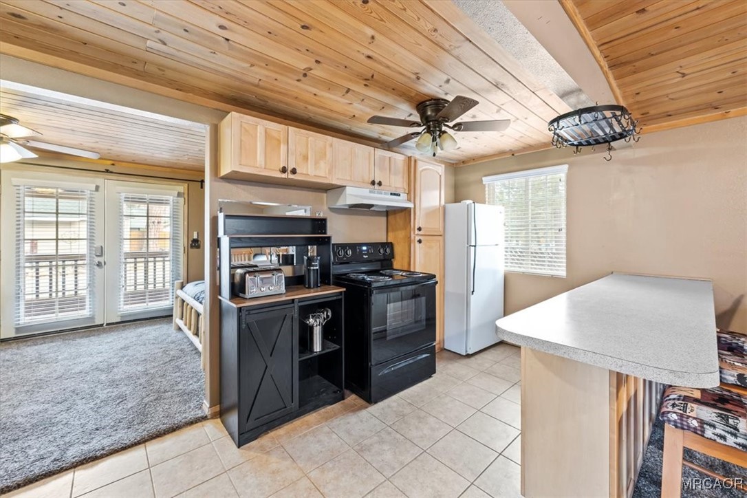 44361 Silver Pine Road Sugarloaf, CA 92386 - Photo 8 of 20 a kitchen with stainless steel appliances granite countertop a stove a sink dishwasher and a refrigerator