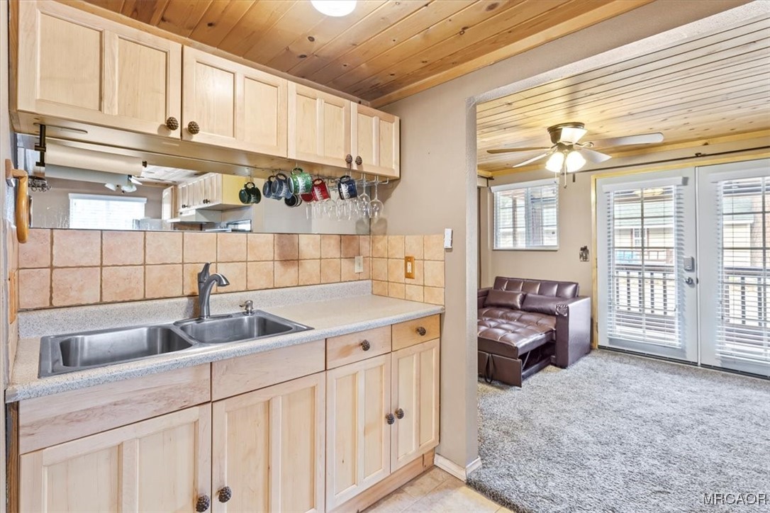 44361 Silver Pine Road Sugarloaf, CA 92386 - Photo 10 of 20 a kitchen with granite countertop a sink a stove and cabinets