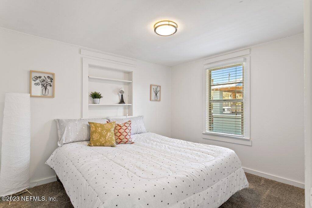 60 Jackson Road Atlantic Beach, FL 32233 - Photo 11 of 42 a bedroom with a bed and a window