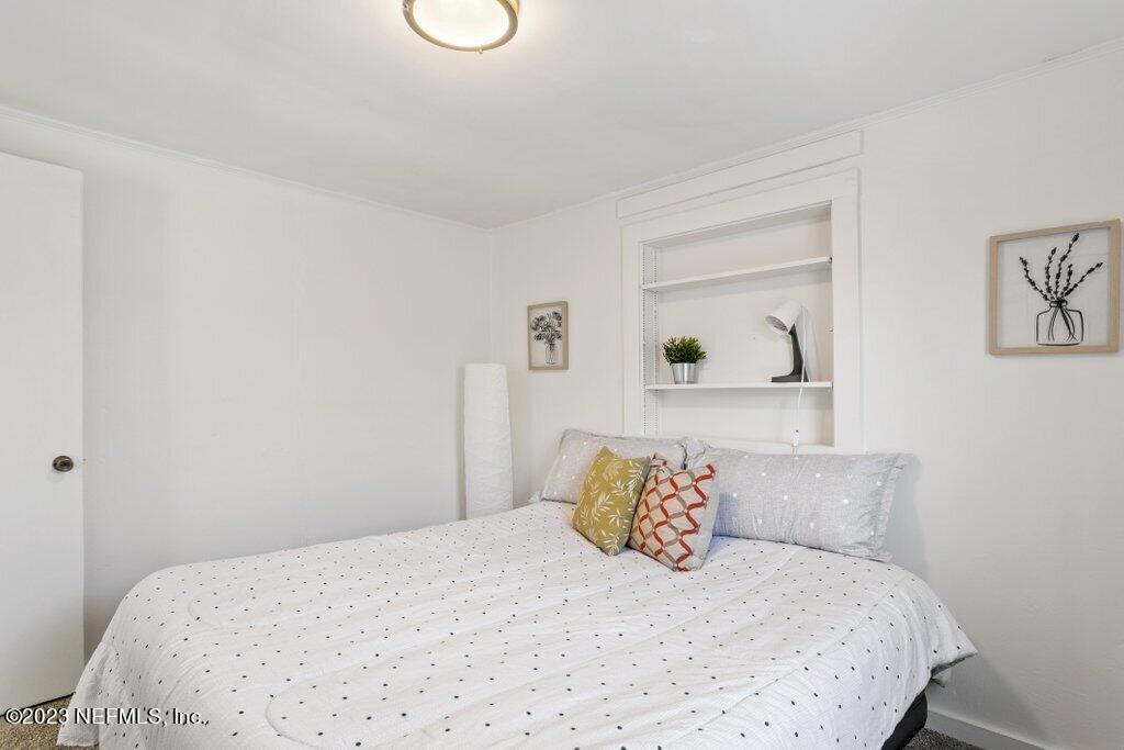 60 Jackson Road Atlantic Beach, FL 32233 - Photo 12 of 42 a bedroom with a bed and painting on the wall