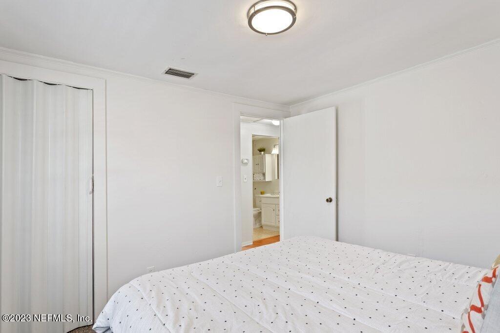 60 Jackson Road Atlantic Beach, FL 32233 - Photo 13 of 42 a bedroom with a bed and a window