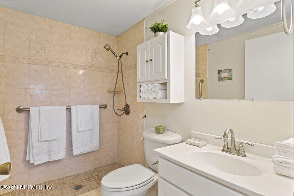 60 Jackson Road Atlantic Beach, FL 32233 - Photo 14 of 42 a bathroom with a sink a toilet a mirror and shower