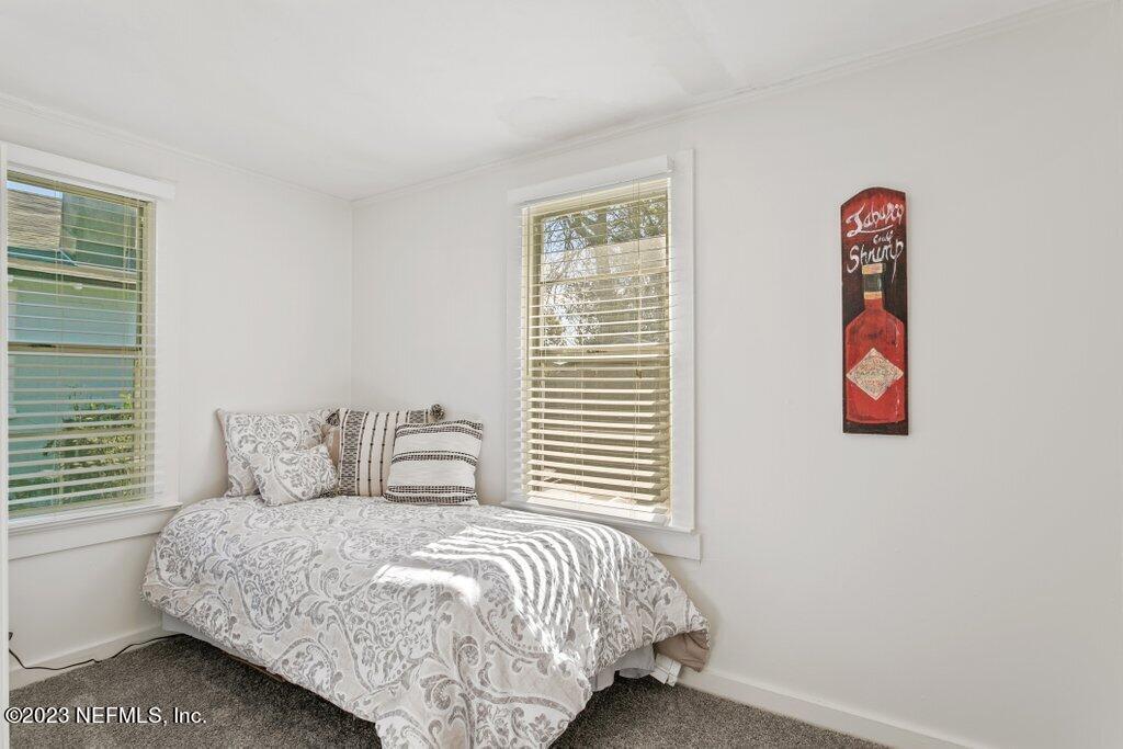 60 Jackson Road Atlantic Beach, FL 32233 - Photo 15 of 42 a bedroom with a bed and a window