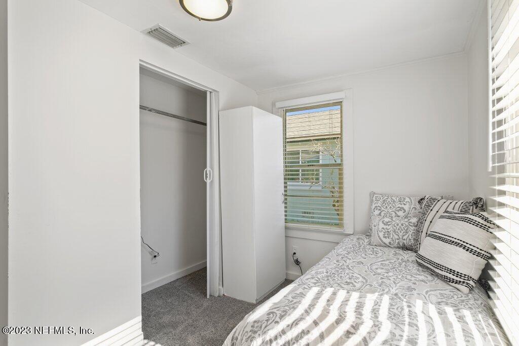 60 Jackson Road Atlantic Beach, FL 32233 - Photo 16 of 42 a bedroom with a bed and a window