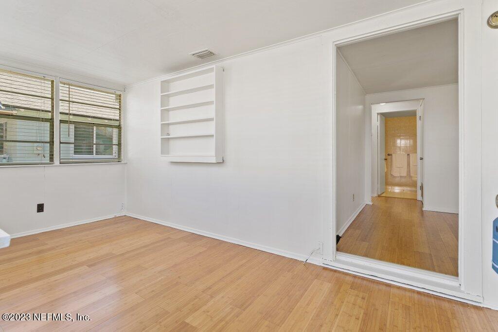 60 Jackson Road Atlantic Beach, FL 32233 - Photo 6 of 42 a view of an empty room with wooden floor and a window