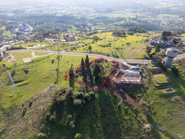 an aerial view of a swimming pool with a yard