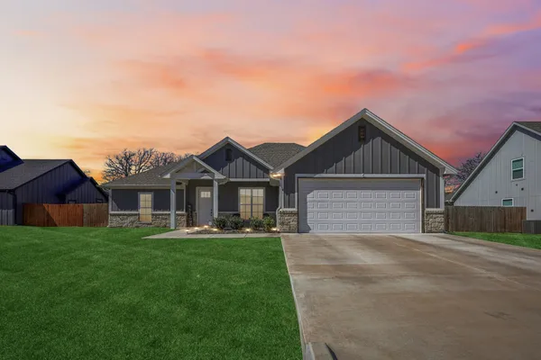 a front view of a house with a yard and garage