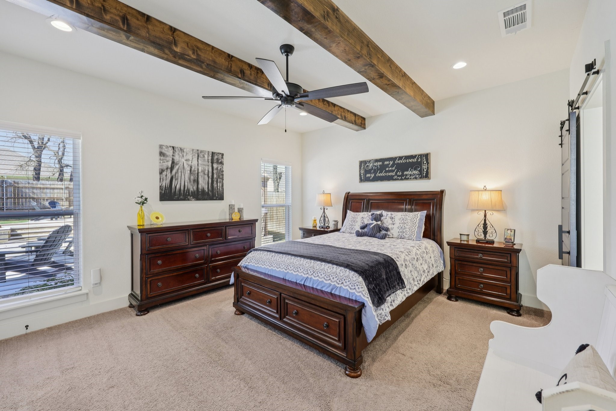 2032 Rattler Way Tolar, TX 76476 - Photo 18 of 49 a spacious bedroom with a bed and a chandelier