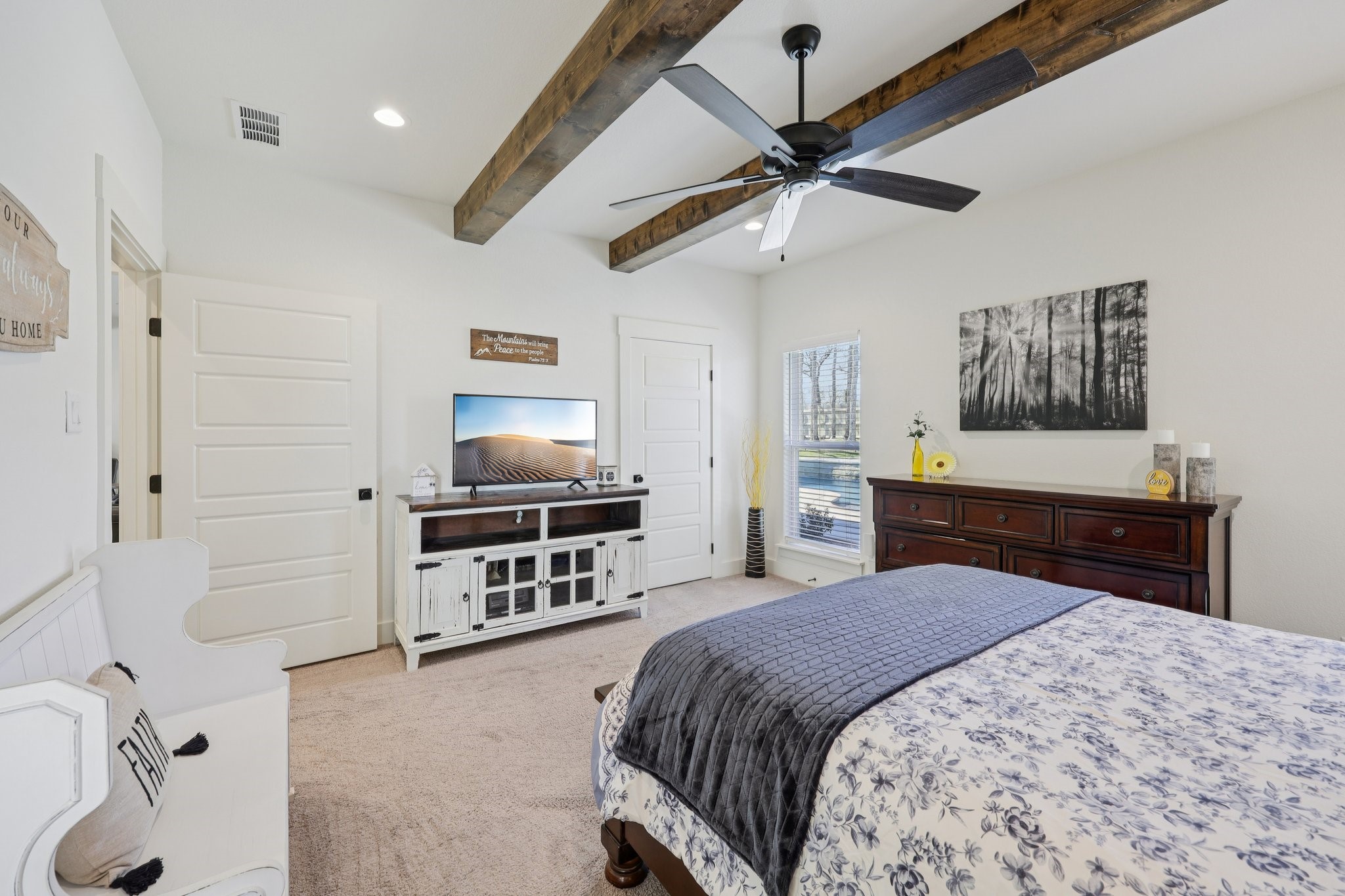 2032 Rattler Way Tolar, TX 76476 - Photo 21 of 49 a bedroom with a bed and a chandelier