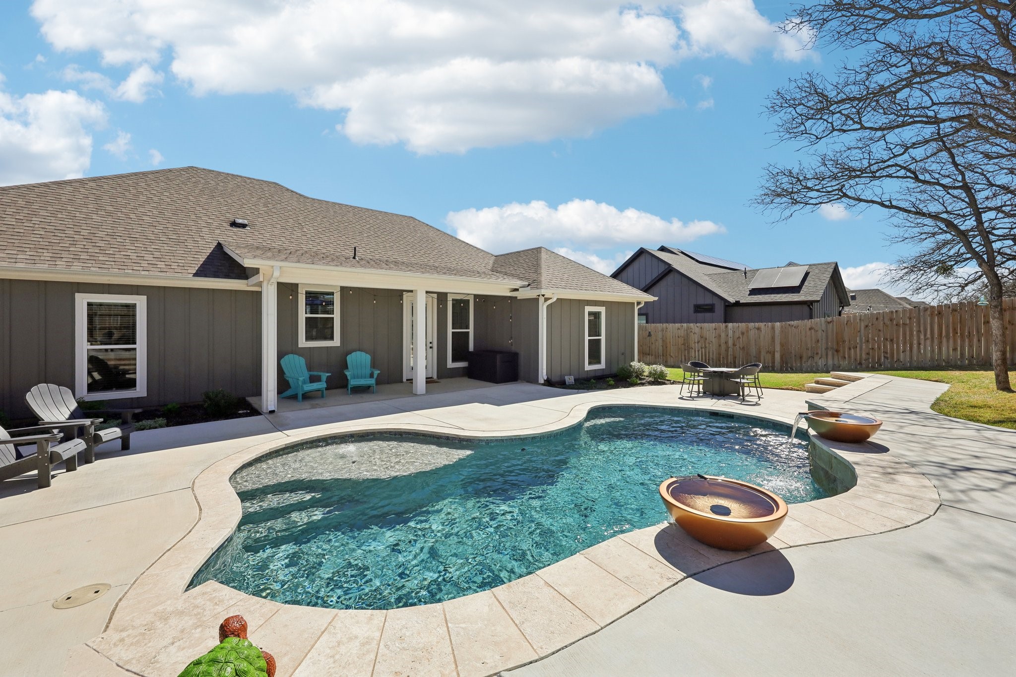 2032 Rattler Way Tolar, TX 76476 - Photo 37 of 49 a front view of a house with swimming pool fire pit and outdoor seating