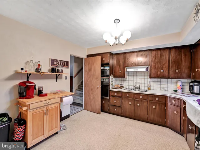 a kitchen that has a lot of cabinets and refrigerator