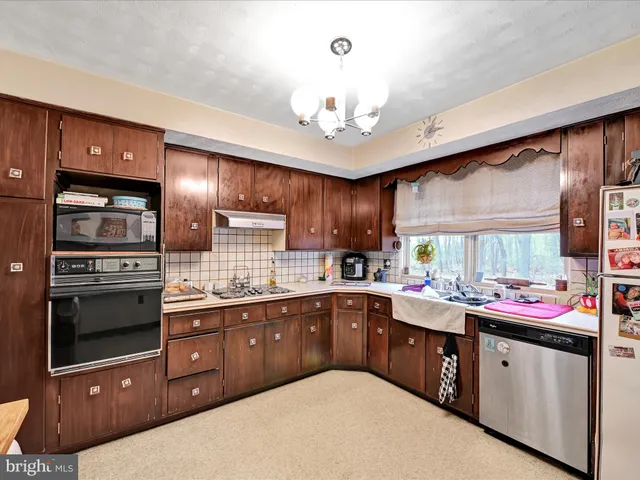 a kitchen with a sink a stove and cabinets
