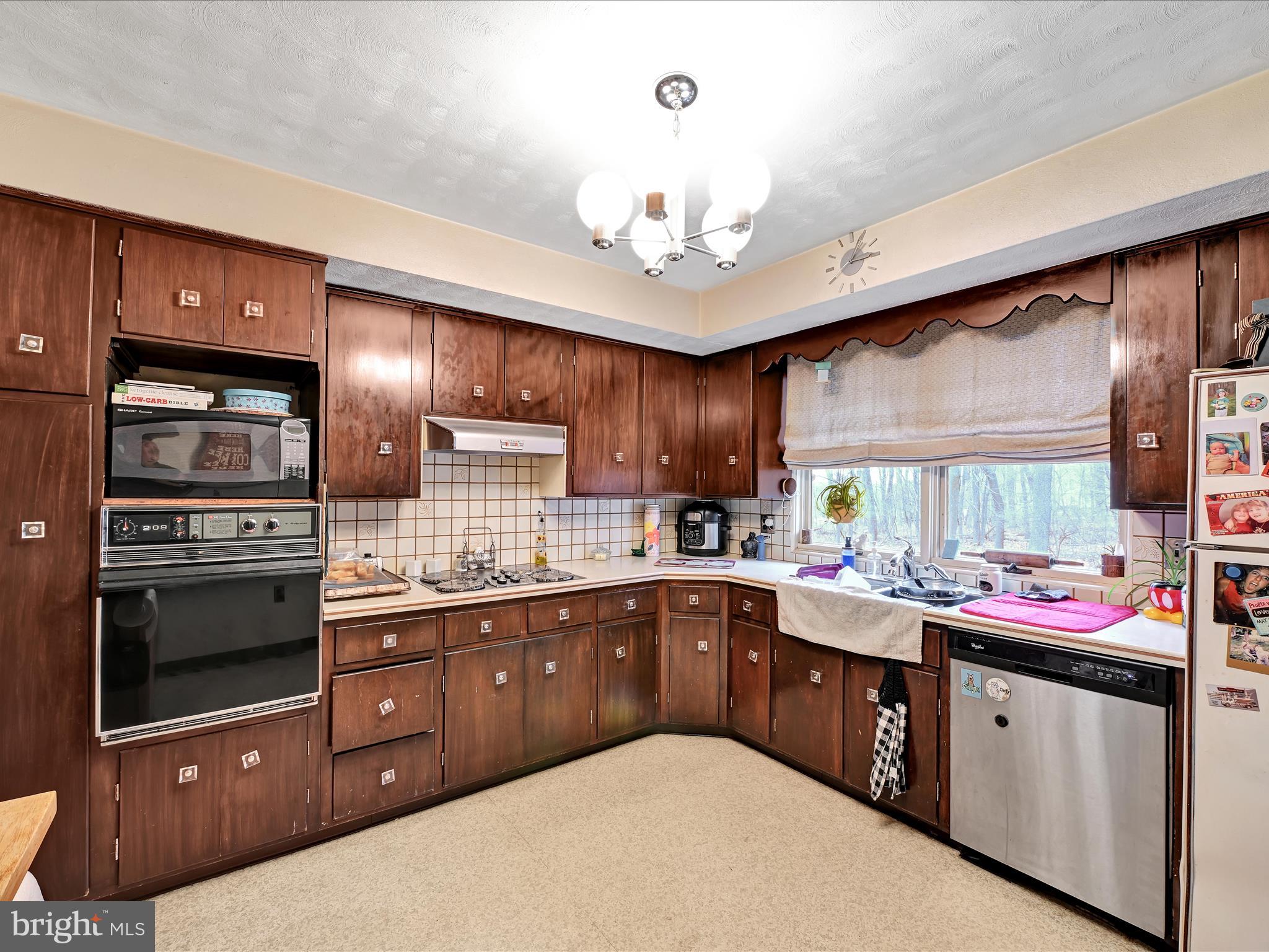 1181 Knights View Road Wrightsville, PA 17368 - Photo 15 of 40 a kitchen with a sink a stove and cabinets
