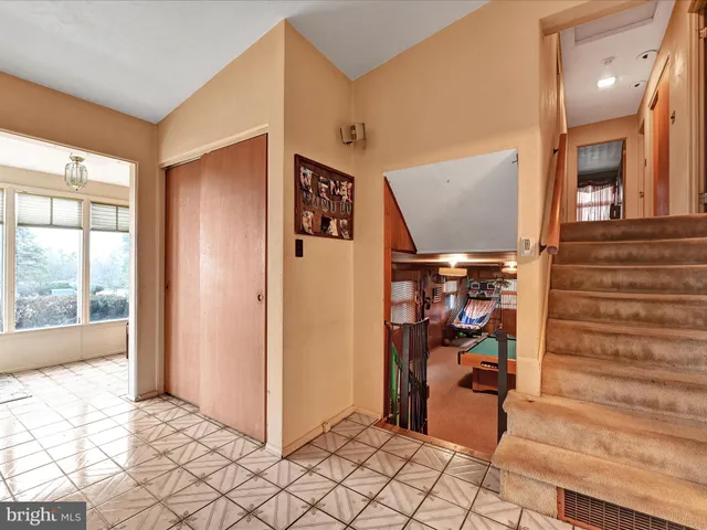 a view of a hallway with wooden floor and entryway