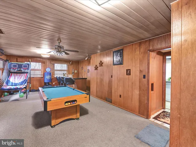 a bedroom with a bed a flat screen tv and a couch