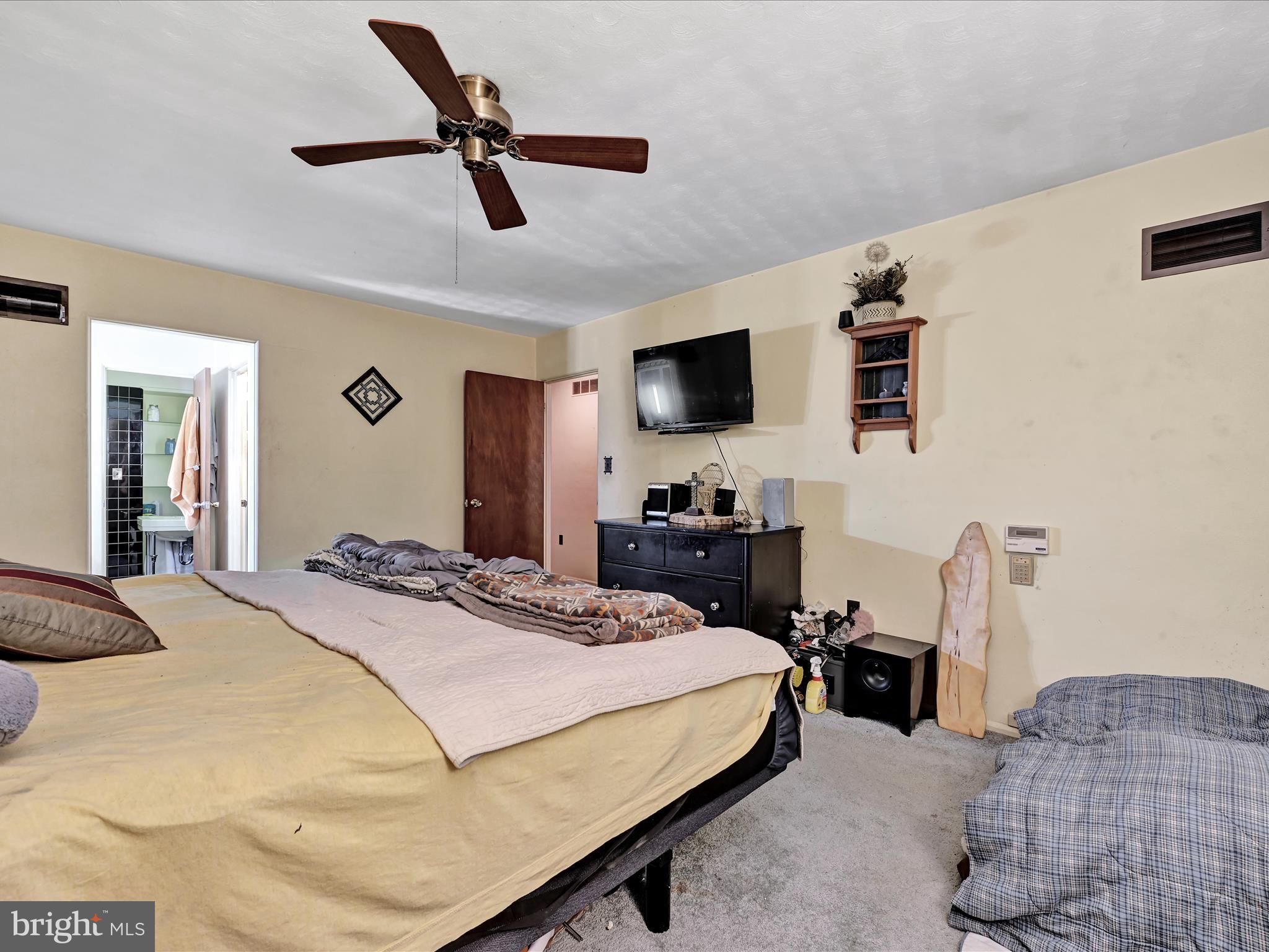 1181 Knights View Road Wrightsville, PA 17368 - Photo 21 of 40 a bedroom with a bed a flat screen tv and a couch