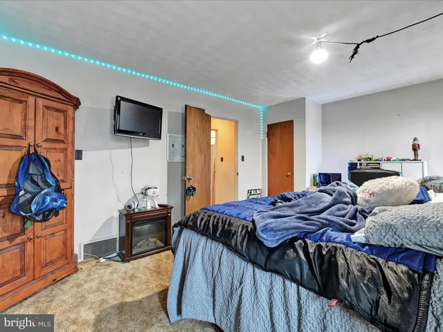 a bed sitting in a bedroom next to a window