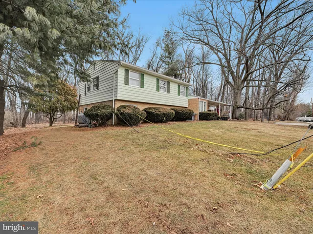 a backyard of a house with large trees