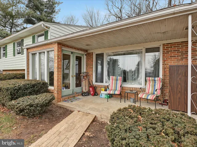 a view of a house with backyard sitting area and garden
