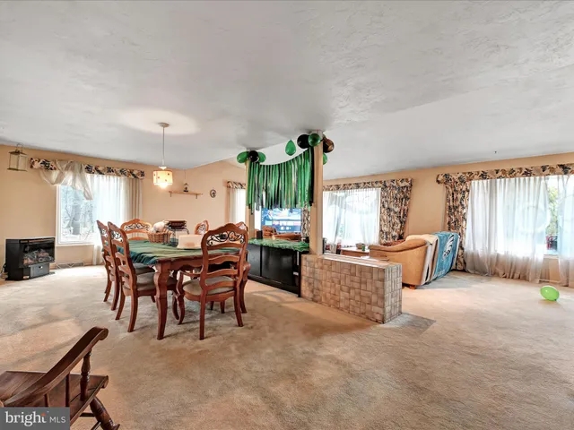 a view of a dining room with furniture and chandelier