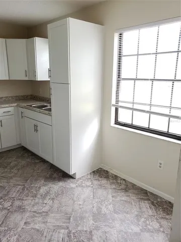 a room with a stove and a refrigerator