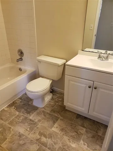 a bathroom with a sink a toilet and bathtub