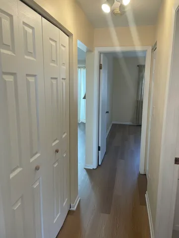 a view of a hallway with wooden floor
