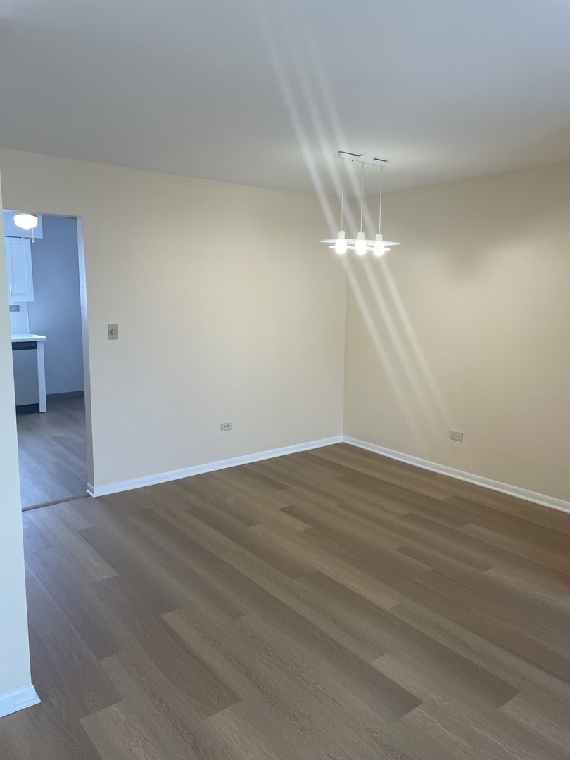 4150 Central Road, Unit 3E Glenview, IL 60025 - Photo 8 of 8 a view of a room with wooden floor
