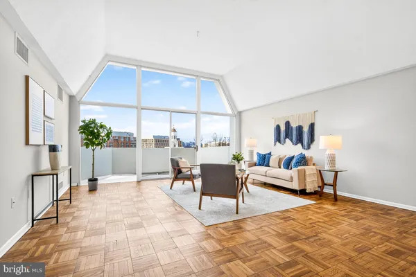 a living room with furniture and a large window