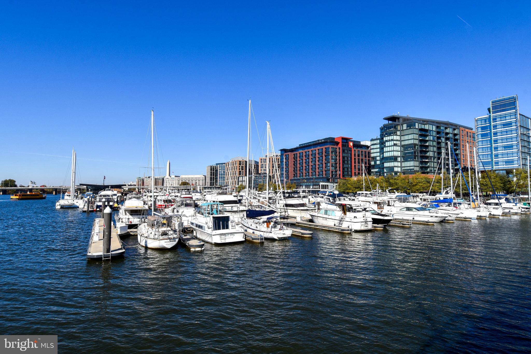 700 7th Street Southwest, Unit 826 Washington, DC 20024 - Photo 33 of 50 Serene marina with modern skyline backdrop.