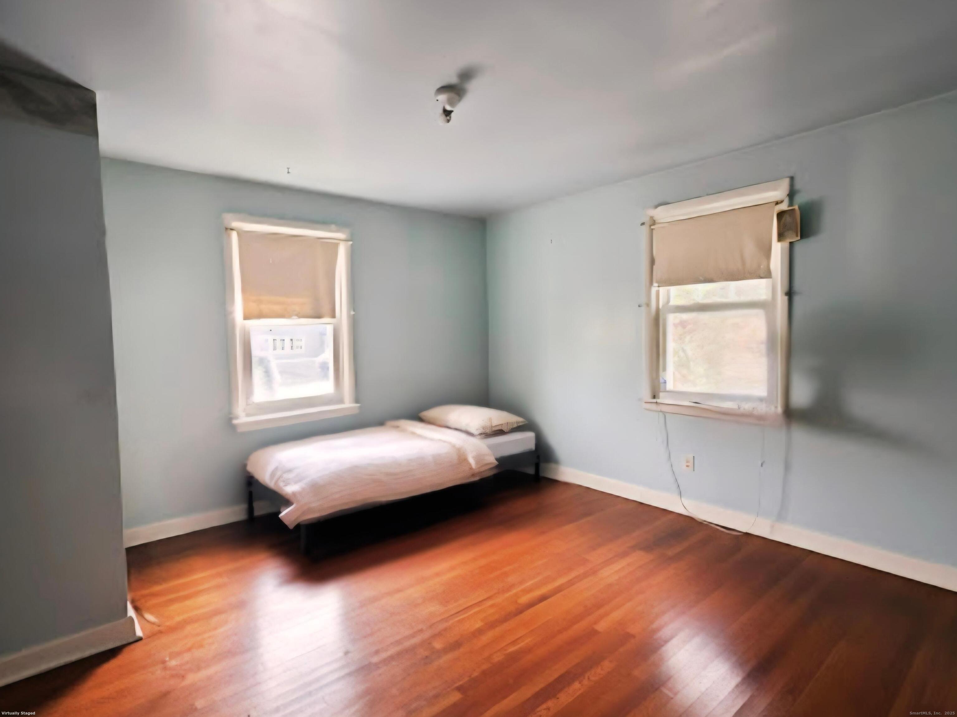 114 Oxford Street Bridgeport, CT 06606 - Photo 4 of 8 a bedroom with a bed and a window