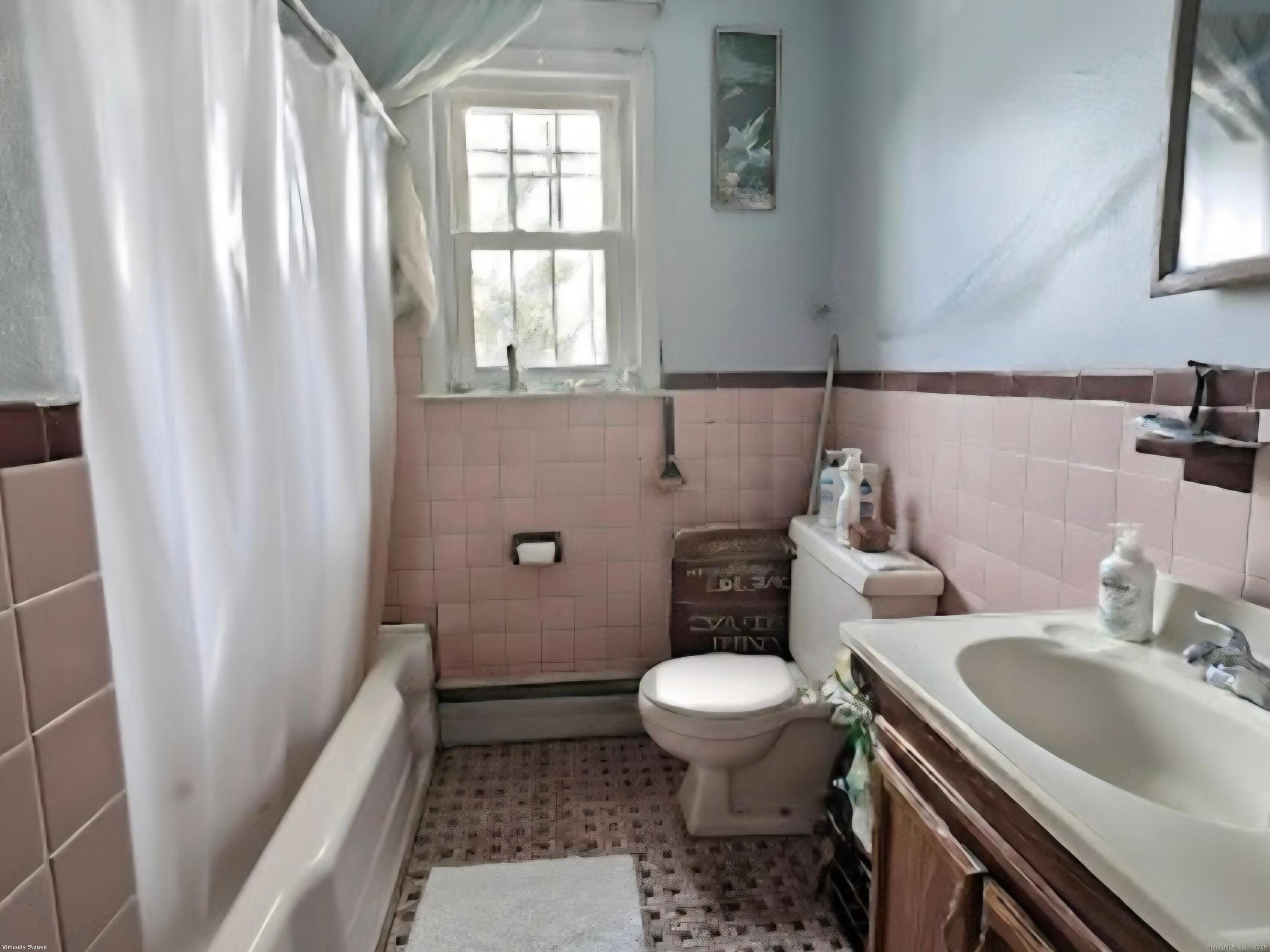 114 Oxford Street Bridgeport, CT 06606 - Photo 5 of 8 a bathroom with a sink toilet and window