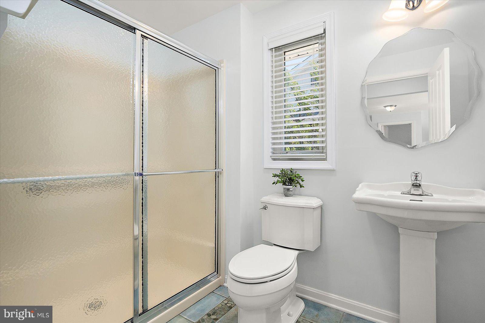 409 Bristol Road South Bethany, DE 19930 - Photo 56 of 89 a bathroom with a sink toilet and shower