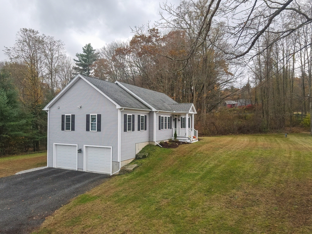 11 Shea Road West Brookfield, MA 01585 - Photo 2 of 42 a view of a white house with a yard and large trees
