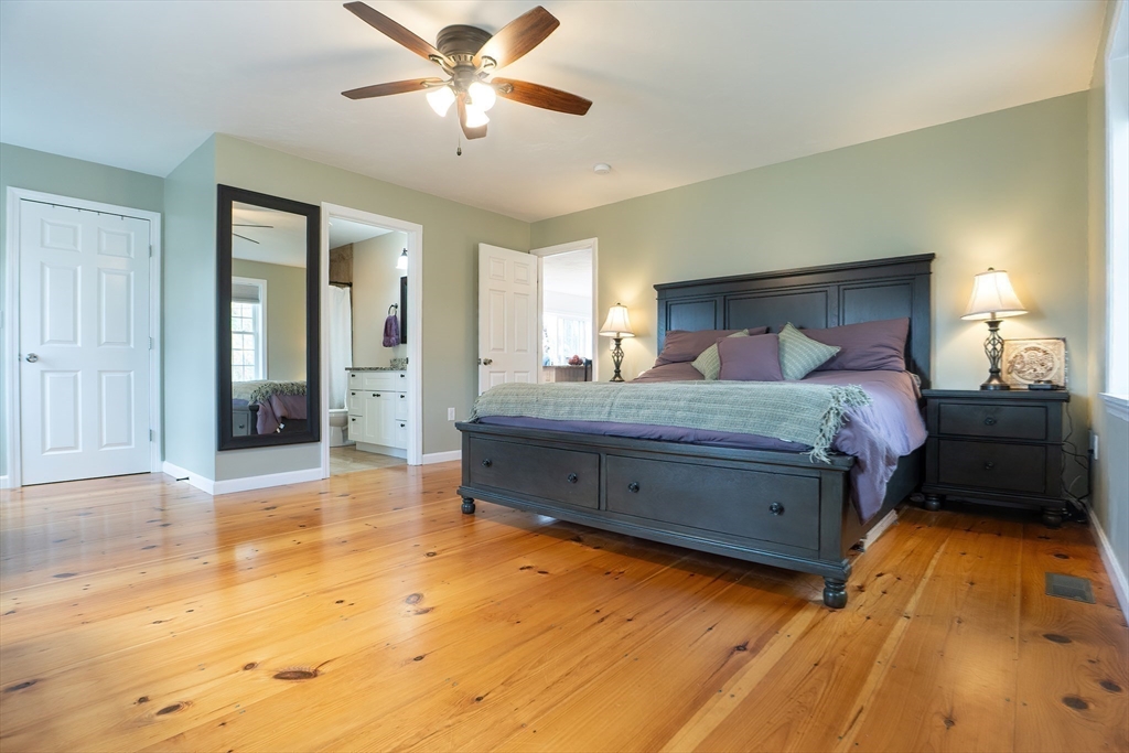 11 Shea Road West Brookfield, MA 01585 - Photo 27 of 42 a bedroom with a bed and a chandelier